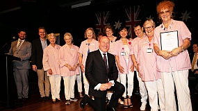 Image of Pink ladies volunteers on stage with local MP