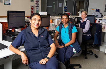 Image of few smiling women clincians seated in front of their computers