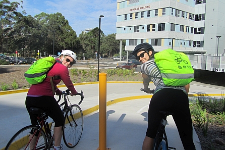 Two cyclist in front of RNS hospital building