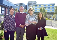 Four award winners standing in front of RNS hospital