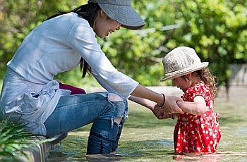 Child and mom playing in water